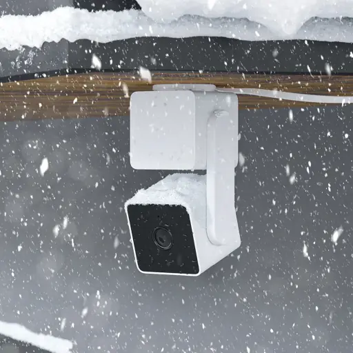 3D lifestyle render showing an outdoor security camera covered in snow, emphasizing its durability in harsh weather conditions.