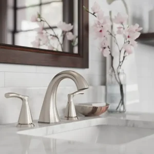 A product lifestyle shot of a modern bathroom faucet with a brushed metal finish on a marble countertop, designed for the home improvement industry.