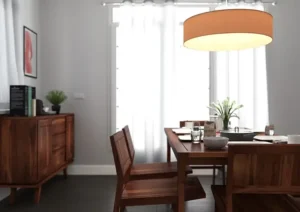 A product lifestyle shot of a dining room with a wooden table, chairs, and a pendant light, designed for the home furnishing industry.