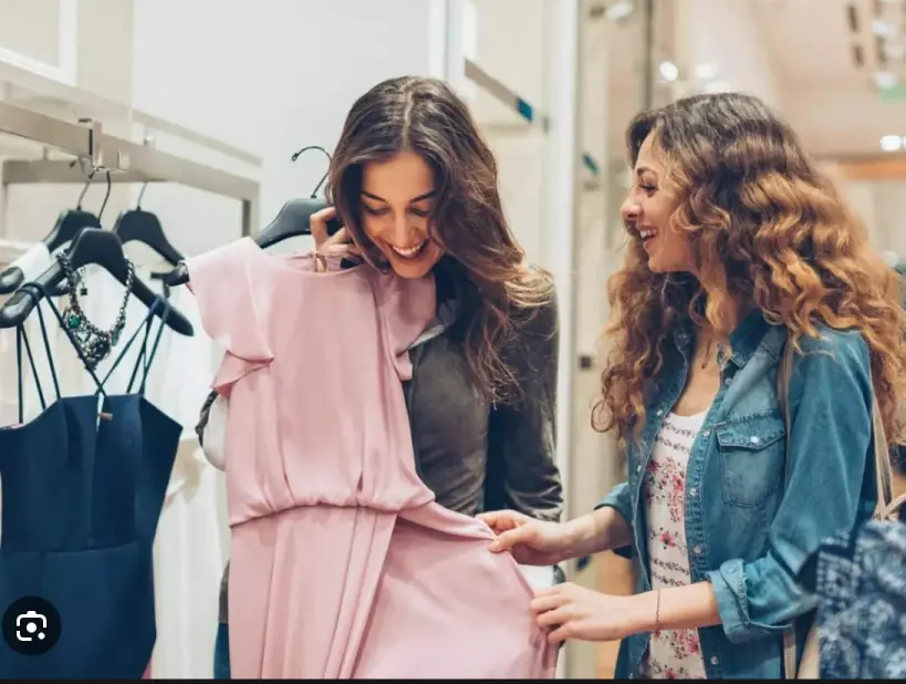 Two friends shopping for clothes together, captured in lifestyle photography.