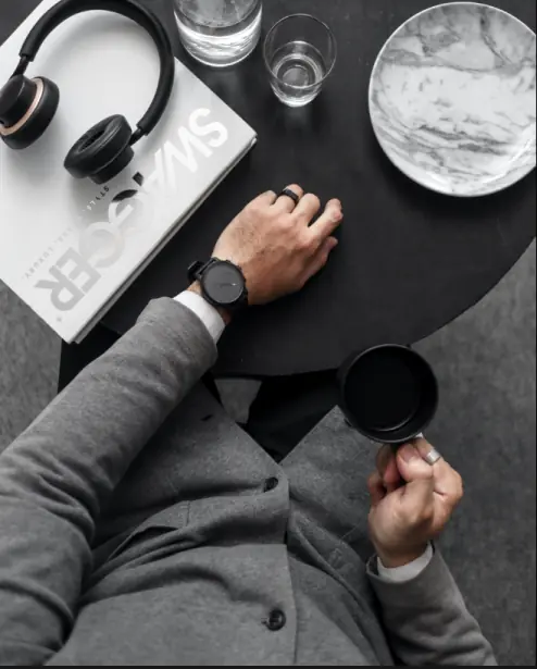 Luxury lifestyle photography highlighting a wristwatch on a man's wrist.